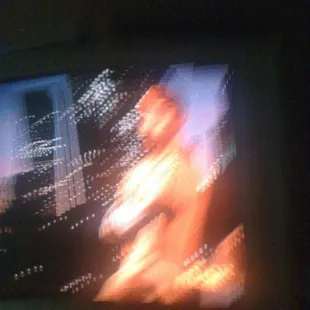a blurry image of a woman on a television screen