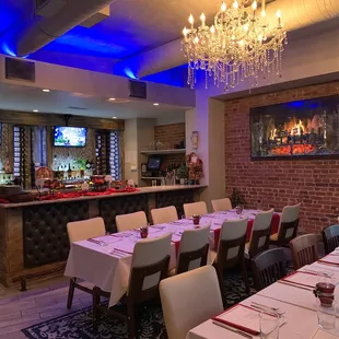 a dining room with a bar and televisions