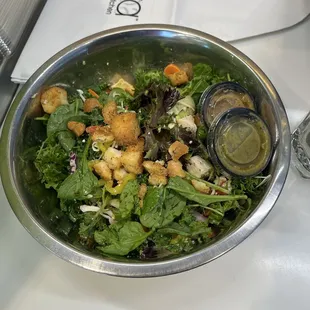 spinach, arugula, kale, avocado, grilled chicken, beets, carrots, banana peppers, cucumbers, strawberries, croutons, and almonds