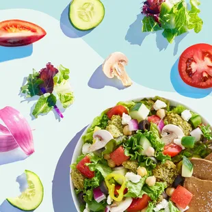 a bowl of salad and sliced vegetables