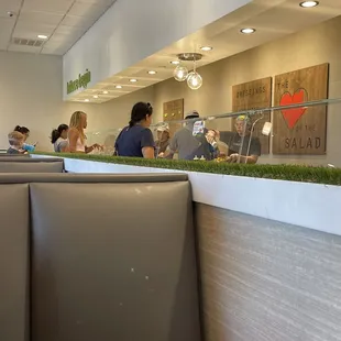 a group of people sitting at a table in a restaurant