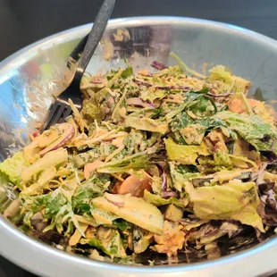 a salad in a bowl with a spoon