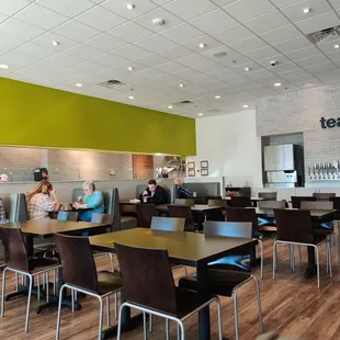 people sitting at tables in a restaurant