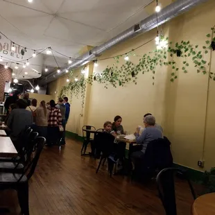 people sitting at tables in a restaurant