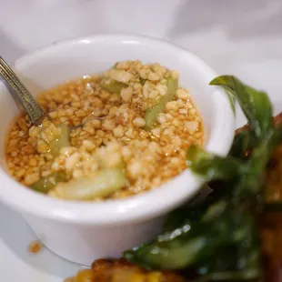 Sour cucumber sauce served with the corn cakes.