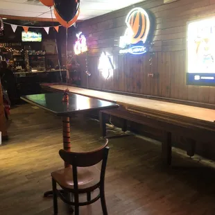 Shuffleboard table and old arcade games on other side.