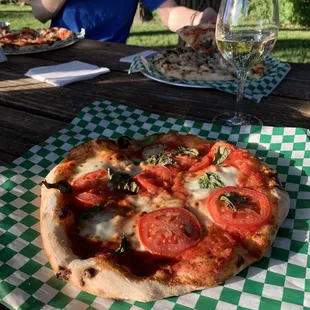 a pizza and a glass of wine