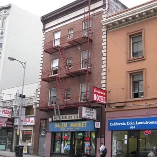 a man walking down the street in front of a store