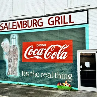 a coca cola sign on the side of a building