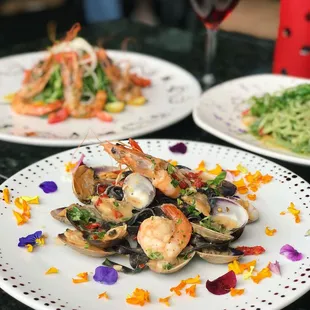 a plate of clams and a glass of wine