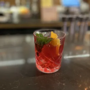 a drink in a glass on a bar
