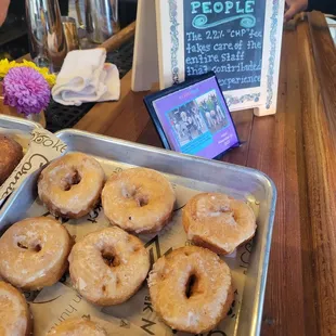 a tray of glazed donuts on a table