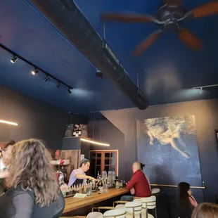 a group of people sitting at a bar