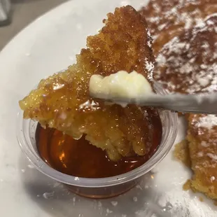 Crunchy French toast with butter and dipped in syrup.
