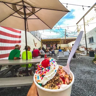 a person holding a cup of ice cream