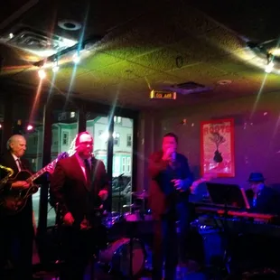 a band playing in a dimly lit room