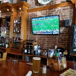 a bar with a television on the wall