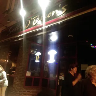 people outside a restaurant at night