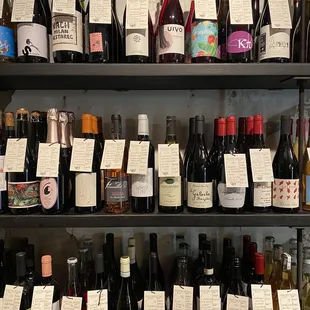 a shelf full of bottles of wine