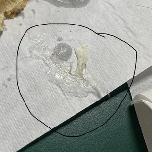 a piece of bread left on a piece of paper