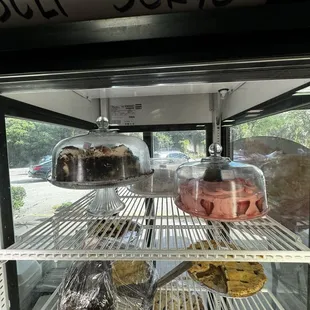 Bakery items in the front case, lost and cream, pie cake, and strawberry cake