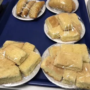 a tray of sandwiches and pastries