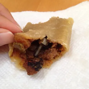 Look what I found in my empanada! They haven't heard the last of me. Don't any one buy any food from here.