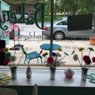 flowers in vases on a window sill