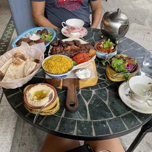 a woman sitting at a table full of food