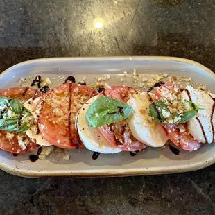 a platter of tomatoes and mozzarella