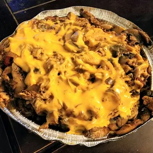 BUFFALO CHICKEN FRIES: chopped boneless/skinless chicken breast, tossed in hot sauce w/peppers &amp; onions, topped w/homemade cheese sauce.
