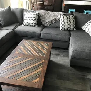 Coffee tables, sectional sofa, pillows, throw and nook table in the background from Salmons.