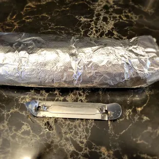 Here is the burrito next to a standard bottle opener. Remember this was 12 bucks!