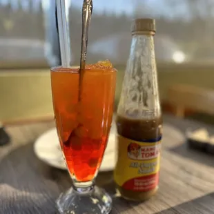 a drink and a bottle of sauce