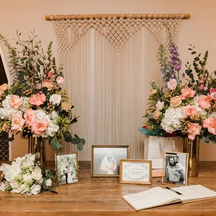 two vases of flowers and a photo of the bride and groom