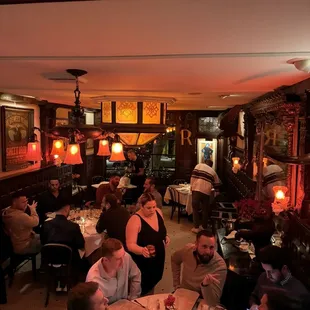 people sitting at tables in a dimly lit room