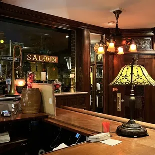 a bar with a lamp on the counter