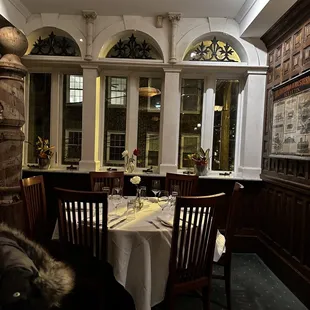 a table with a white tablecloth and chairs