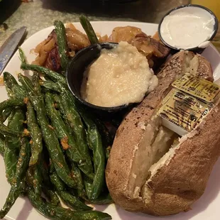 Two medallions with onion and garlic purée with teriyaki green beans and baked potato