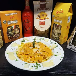 a plate of pasta with cheese and sauce