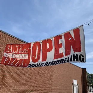 an open sign on the side of a building