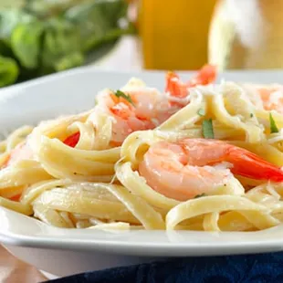 a plate of pasta with shrimp