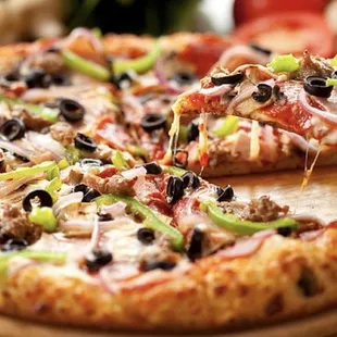 a sliced pizza on a wooden board