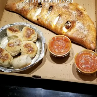 Family size calzone with pepperoni and mushrooms, and side of garlic knots.   Ovtober 2019.