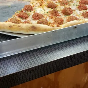 Spaghetti and meatballs pizza