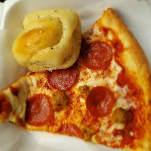The sausage and pepperoni pizza slice with a garlic roll thing.