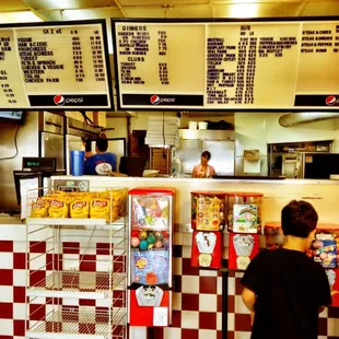 a boy standing in front of the counter
