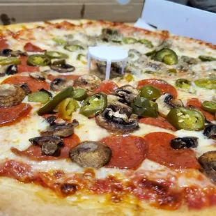 Pizza with mushrooms, pepperoni, and jalapeños!