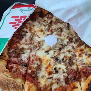 a pizza in a paper bag