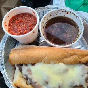 a sub and a bowl of sauce
